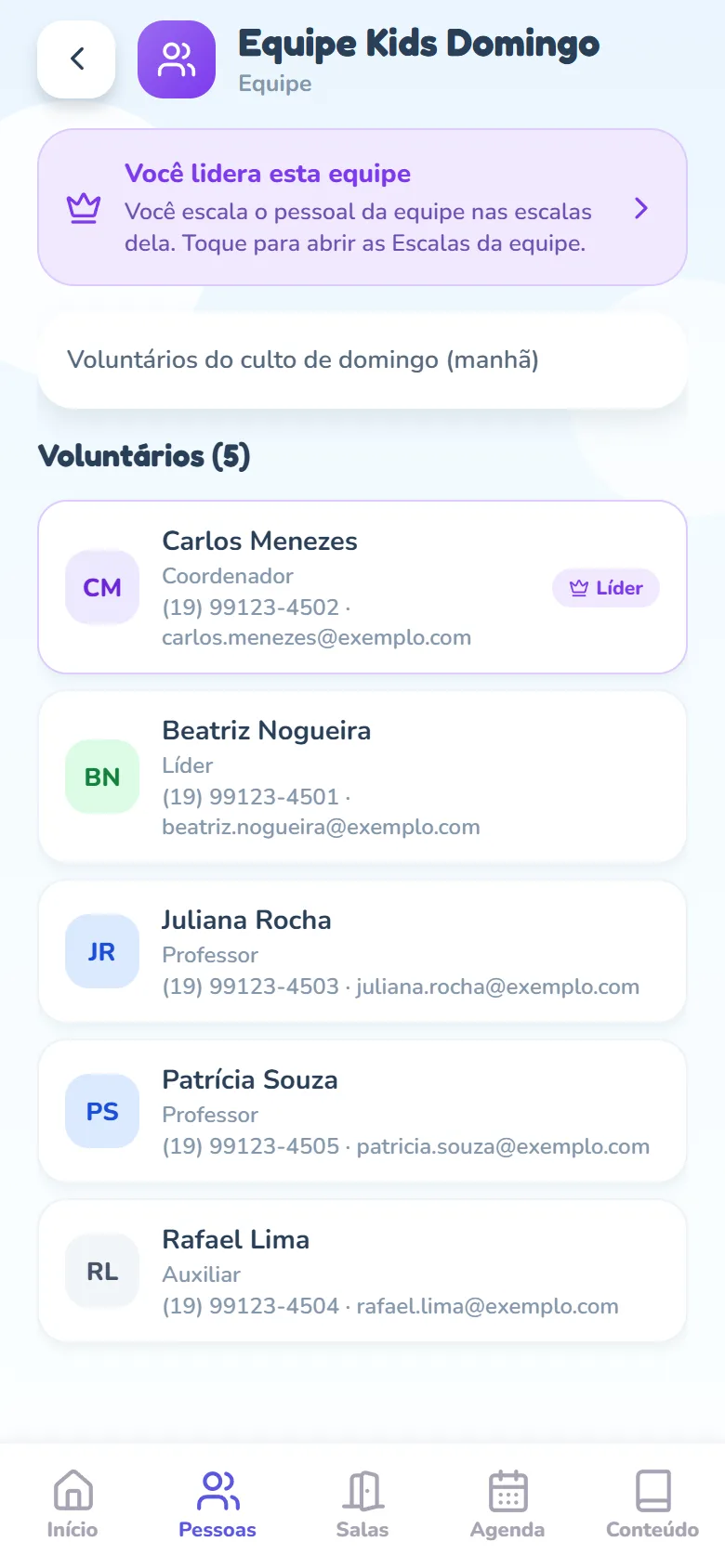 Página da Equipe Kids Domingo vista pelo Carlos: o aviso roxo Você lidera esta equipe, com uma coroa e o texto Você escala o pessoal da equipe nas escalas dela. Toque para abrir as Escalas da equipe., a descrição da equipe e Voluntários (5), com Carlos Menezes primeiro e o selo Líder, seguido de Beatriz Nogueira, Juliana Rocha, Patrícia Souza e Rafael Lima, cada um com o cargo, o telefone e o e-mail.